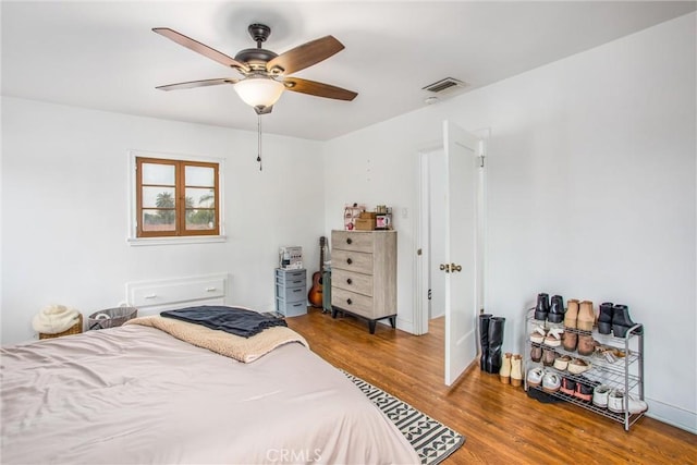 bedroom with wood-type flooring and ceiling fan