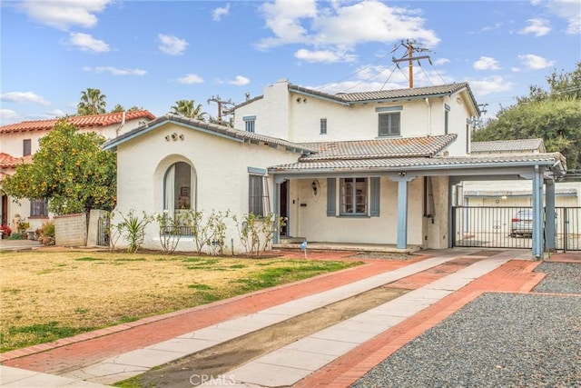 mediterranean / spanish-style house featuring a front yard