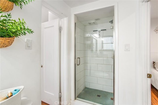 bathroom featuring a shower with door