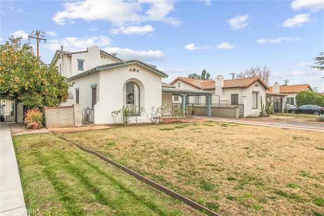 mediterranean / spanish-style home featuring a front yard