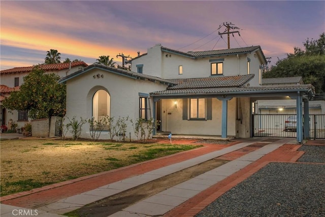 mediterranean / spanish home featuring a yard