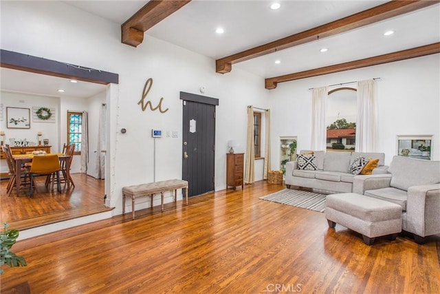 living room featuring beamed ceiling and hardwood / wood-style floors