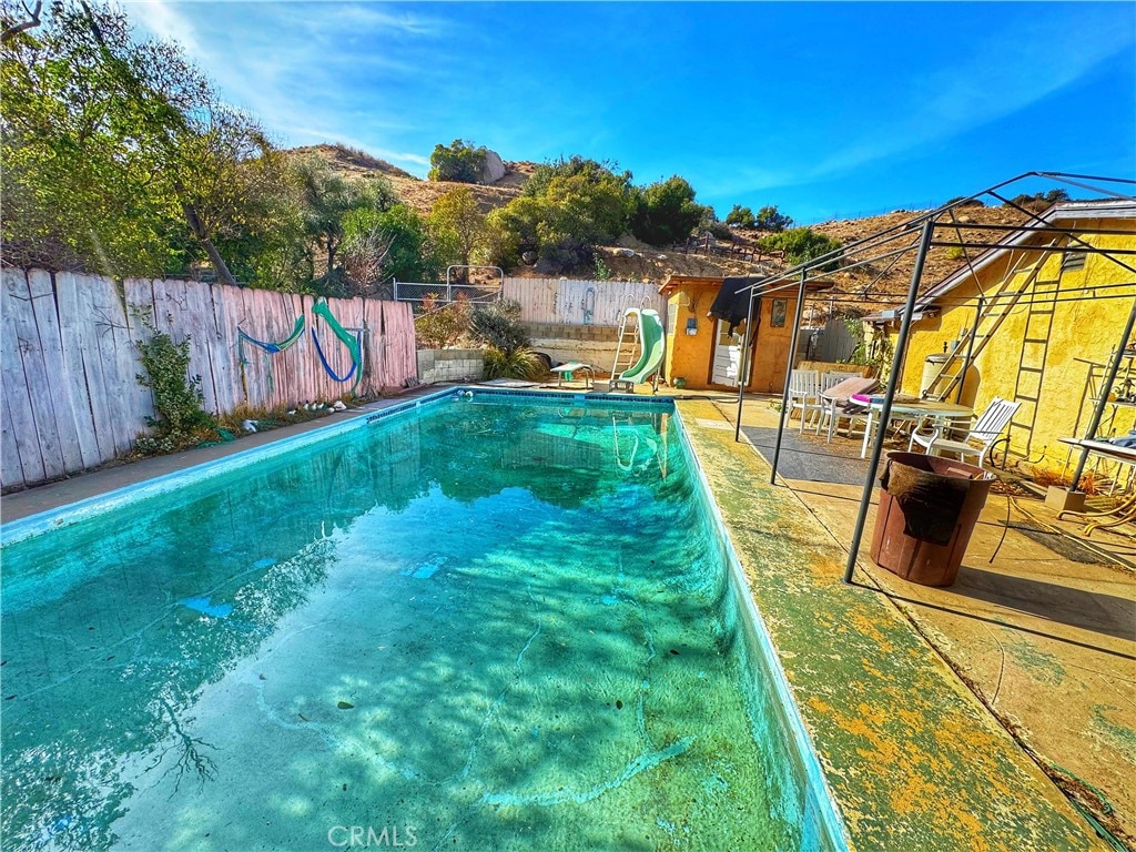 view of swimming pool with a water slide