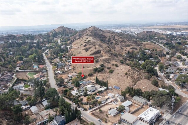 birds eye view of property featuring a mountain view