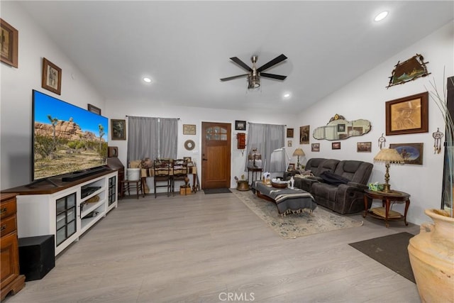 living room with vaulted ceiling, recessed lighting, light wood-style flooring, and a ceiling fan