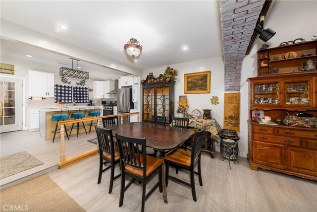 dining space with light wood-style flooring and recessed lighting