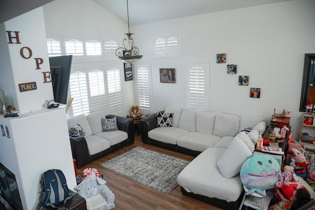 living room featuring hardwood / wood-style floors and vaulted ceiling