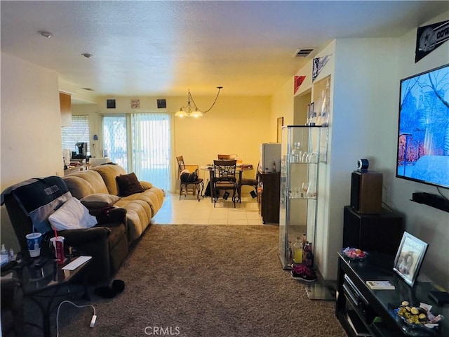 living room with a notable chandelier and light tile patterned flooring