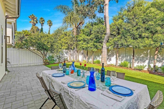 view of patio with a hot tub and a water view