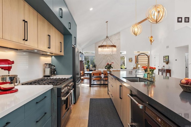 kitchen with sink, a chandelier, hanging light fixtures, stainless steel appliances, and light brown cabinets