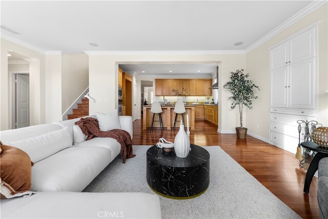 living room featuring ornamental molding and dark wood-type flooring