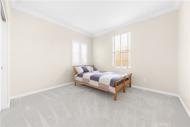 carpeted bedroom featuring crown molding