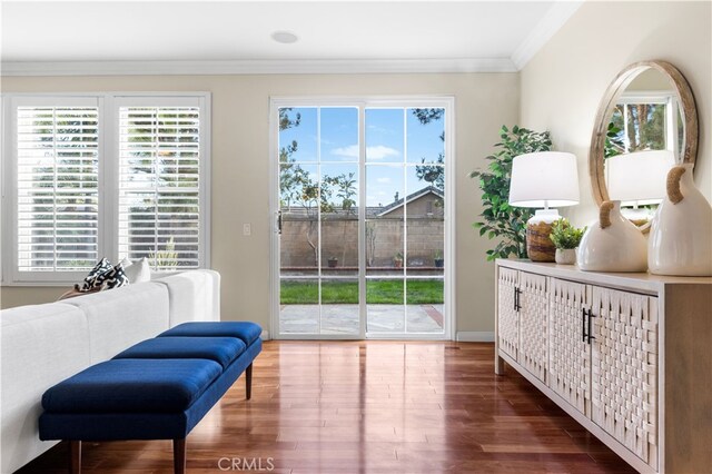 sitting room with crown molding and hardwood / wood-style flooring