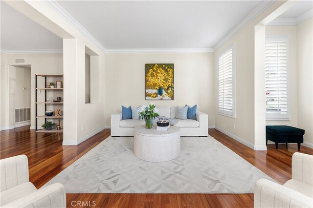 living room featuring wood-type flooring and ornamental molding