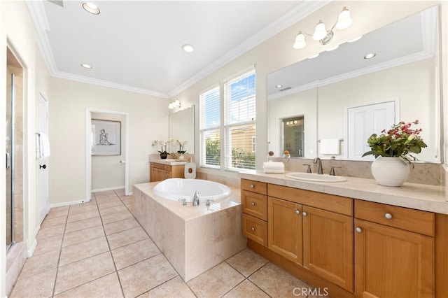 bathroom with ornamental molding, tiled bath, vanity, and tile patterned floors