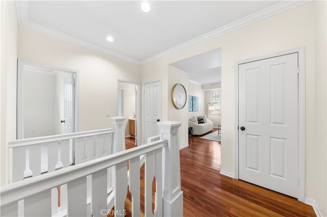 hall featuring ornamental molding and hardwood / wood-style floors