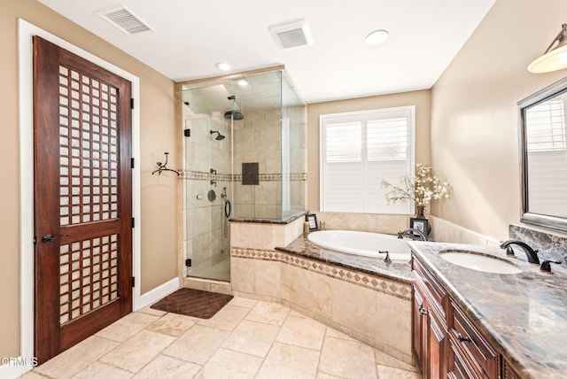 bathroom featuring vanity, a wealth of natural light, and plus walk in shower