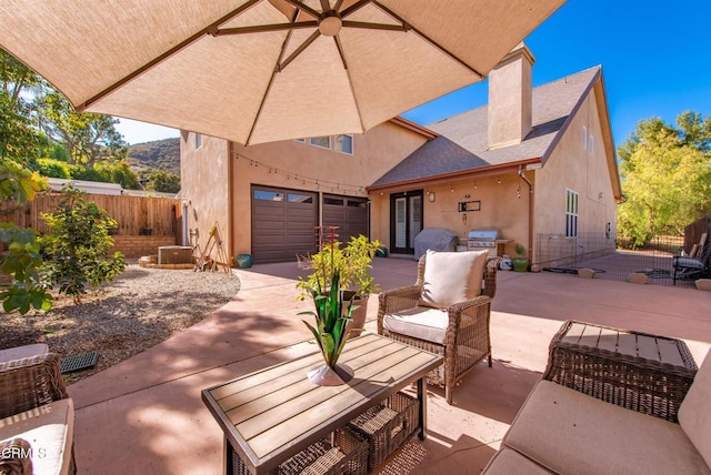 view of patio with a garage and area for grilling