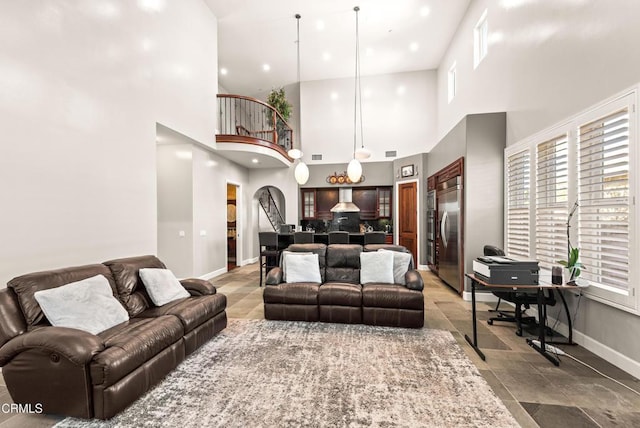 living room featuring a towering ceiling