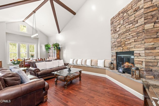 living room featuring a fireplace, beam ceiling, dark wood-type flooring, and high vaulted ceiling