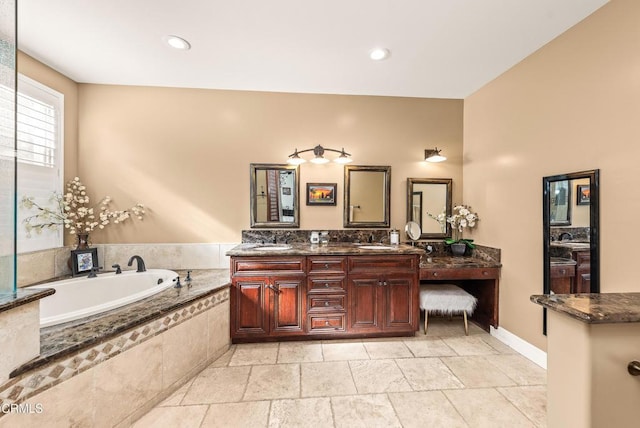 bathroom featuring vanity and a relaxing tiled tub