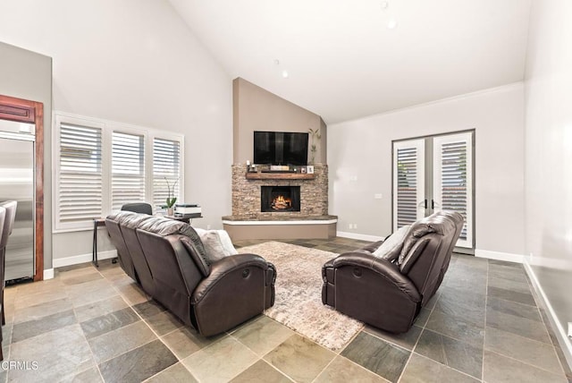 living room featuring a stone fireplace and high vaulted ceiling