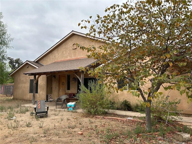 view of front of property with a patio area and a fire pit