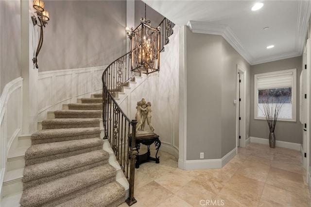 stairs with crown molding and a chandelier