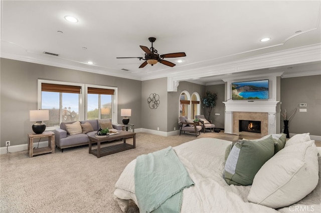 bedroom with light carpet, crown molding, and ceiling fan