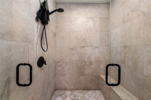 bathroom with a shower with door