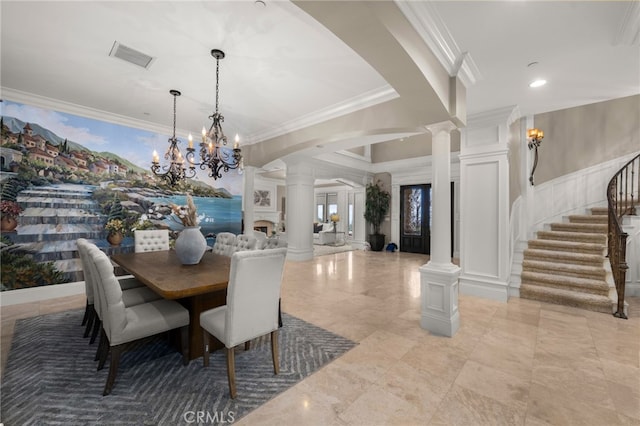 dining space featuring ornamental molding and ornate columns