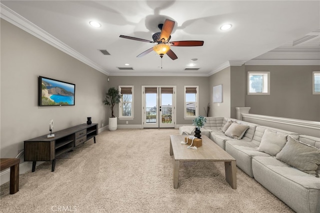carpeted living room featuring crown molding and ceiling fan