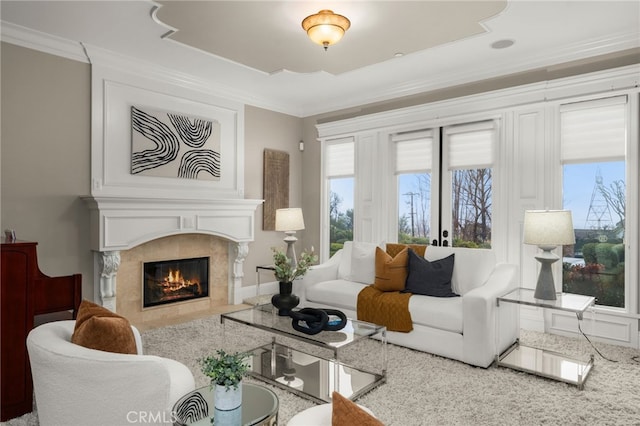 living room with ornamental molding and a high end fireplace