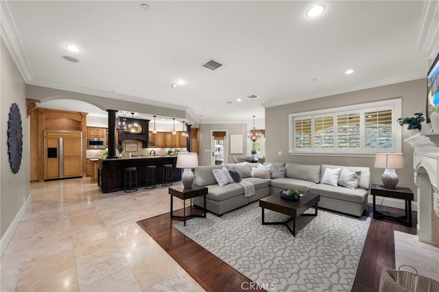 living room featuring ornamental molding and a notable chandelier