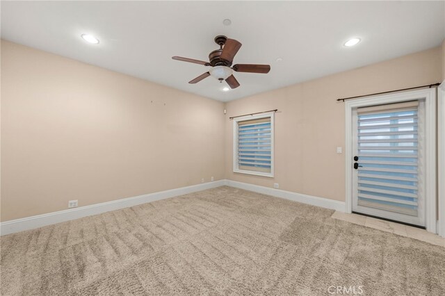 carpeted empty room featuring ceiling fan