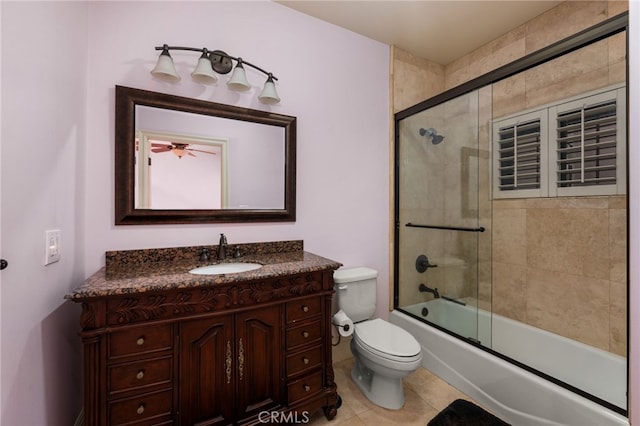 full bathroom featuring vanity, tile patterned floors, enclosed tub / shower combo, and toilet