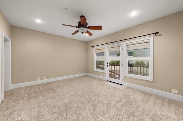 empty room with ceiling fan, light colored carpet, and french doors