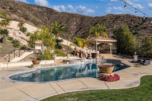 view of pool with a mountain view and a patio area