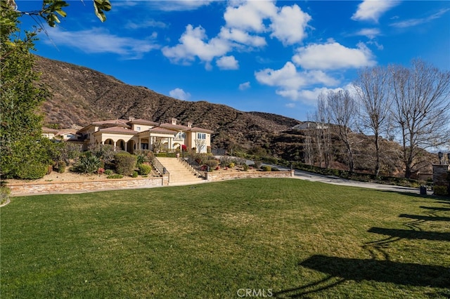 exterior space with a mountain view and a yard