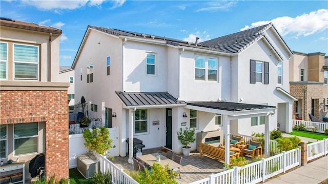 view of front of home with an outdoor hangout area and a patio area