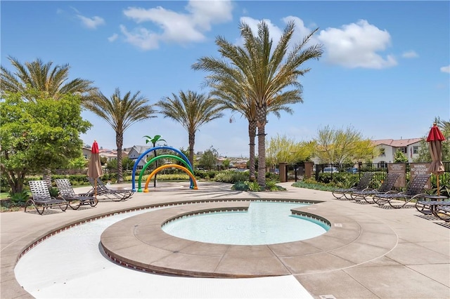 view of swimming pool with a playground