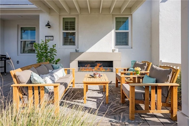 view of patio / terrace featuring an outdoor living space with a fireplace