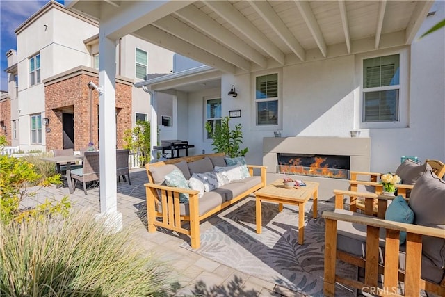 view of patio / terrace featuring an outdoor living space with a fireplace