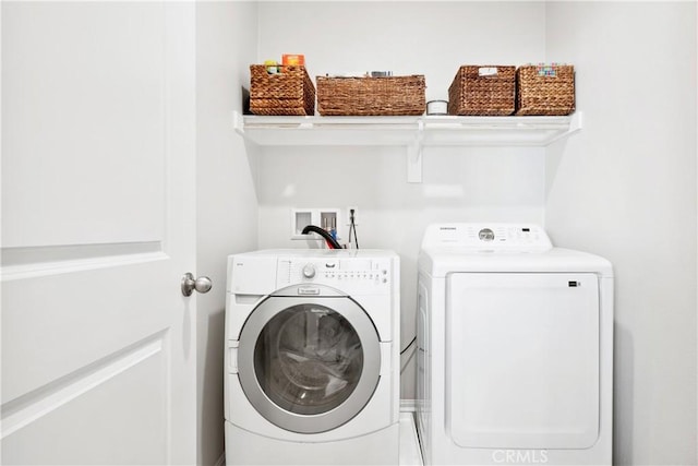 clothes washing area with washing machine and dryer