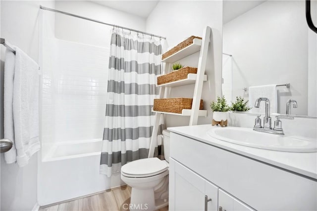 full bathroom featuring shower / tub combo, vanity, wood-type flooring, and toilet