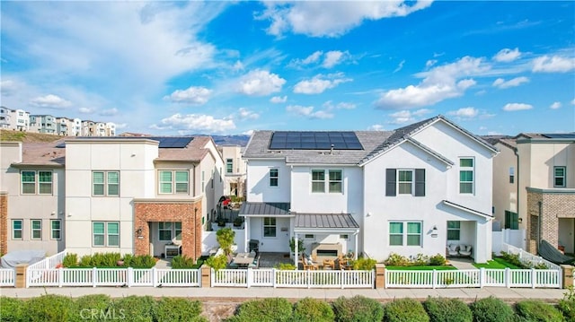 view of front of property featuring solar panels