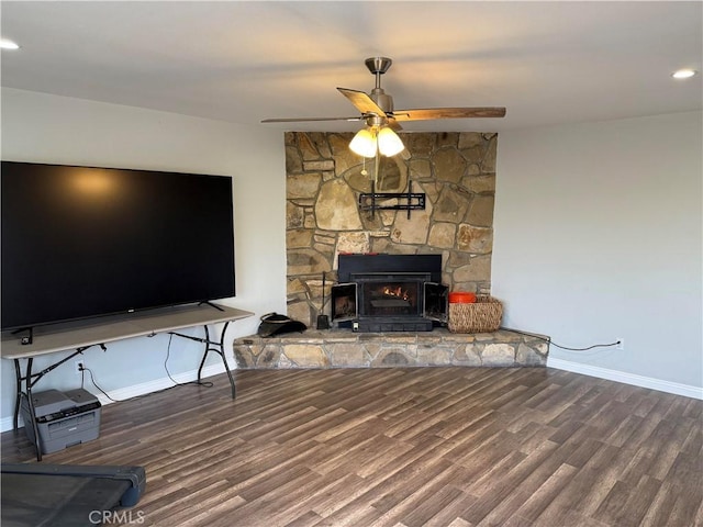 living room featuring ceiling fan, a fireplace, and hardwood / wood-style floors