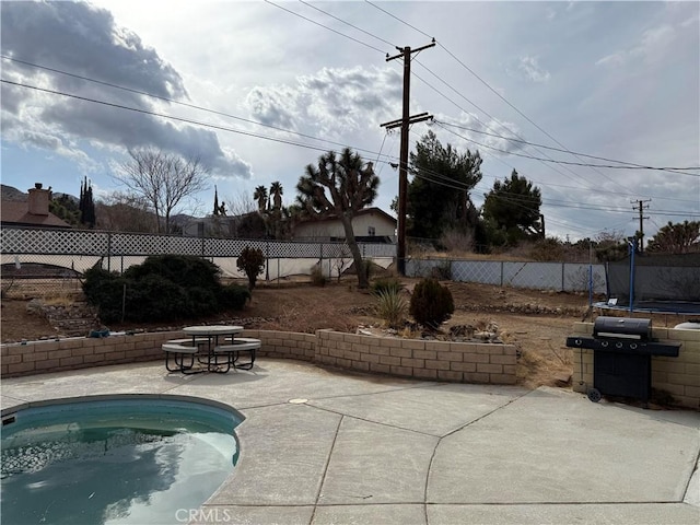 view of patio featuring area for grilling and a trampoline