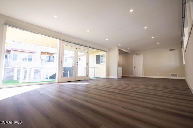 spare room featuring dark hardwood / wood-style flooring and french doors