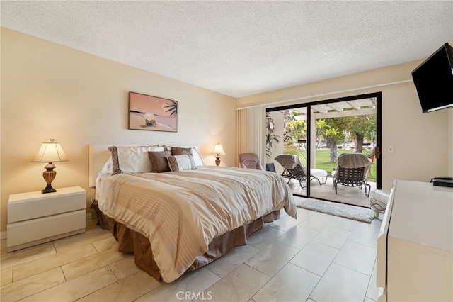 bedroom with a textured ceiling and access to outside